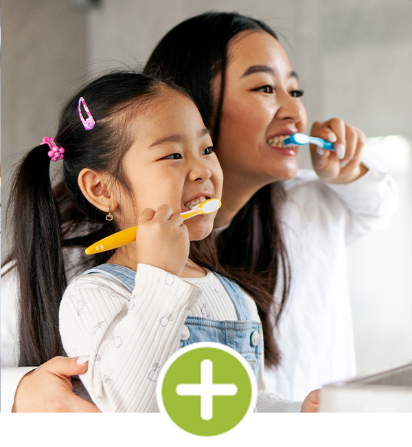 mom and daughter brushing their teeth